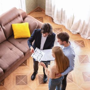 above-view-of-real-estate-agent-showing-house-plan-2026-01-08-23-10-48-utc