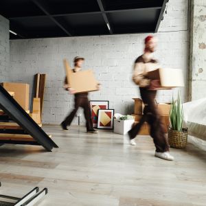 blurred-motion-of-loaders-in-workwear-carrying-pac-2026-03-24-04-36-10-utc